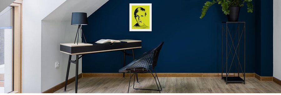 The same print at a smaller size above a desk and the same wire chair