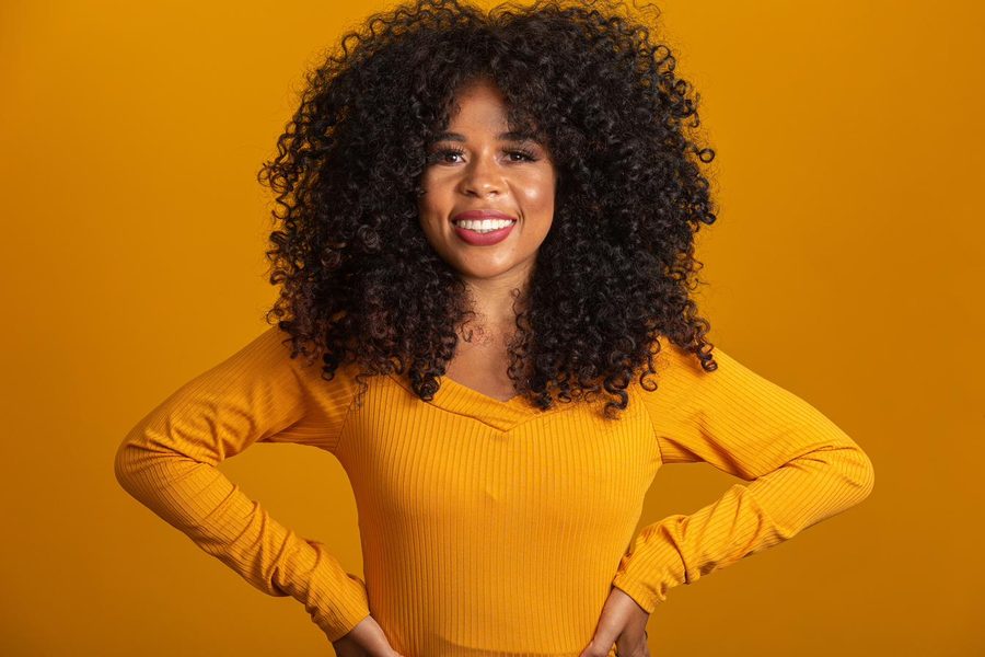 Danielle, arms confident on her hips