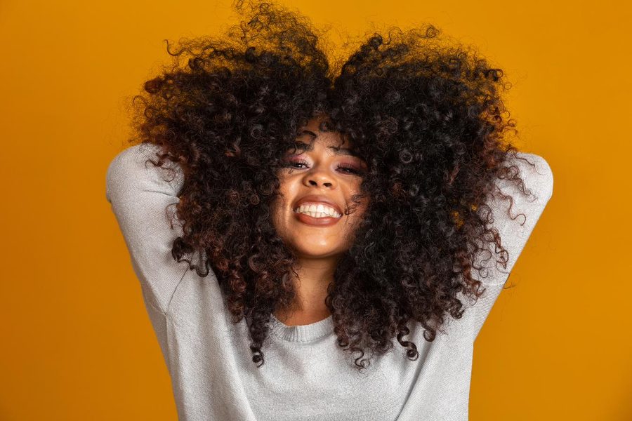 Danielle, hands in her hair, delighted