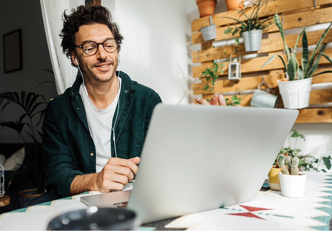 A founder working remotely, leading his team on a video call